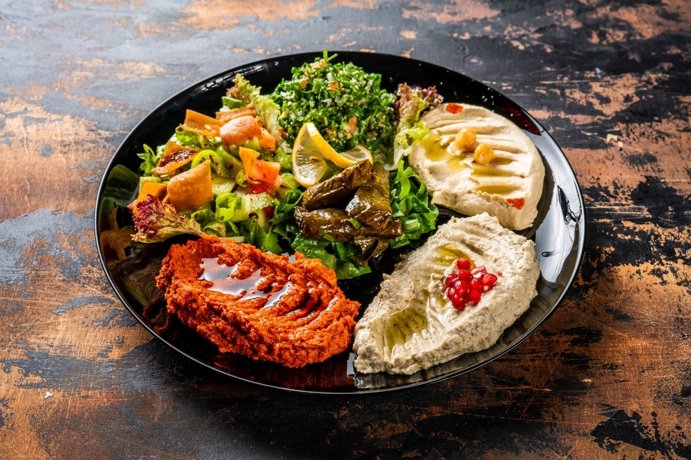 MEZZE PLATTER or mezzeh hummus on a wooden surface