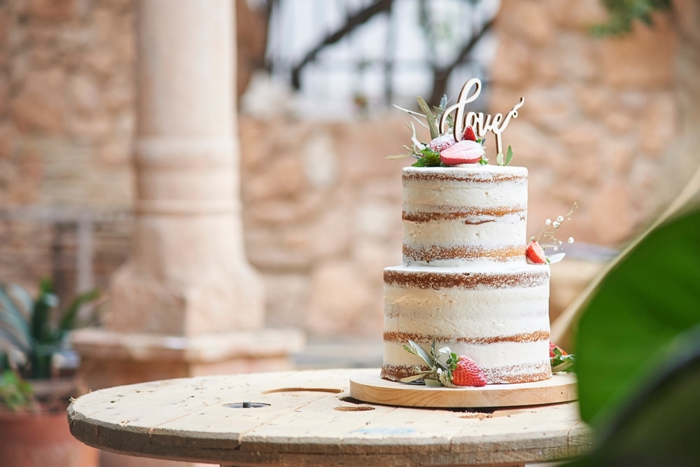 delicious wedding rustic cake on wooden table 