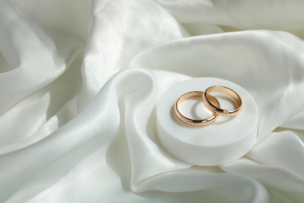  Gold Wedding Rings On White Satin Fabric Marriage