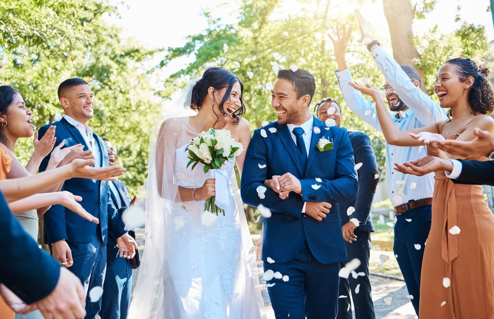 Wedding Ceremony And Couple Walking With Petals And Guests