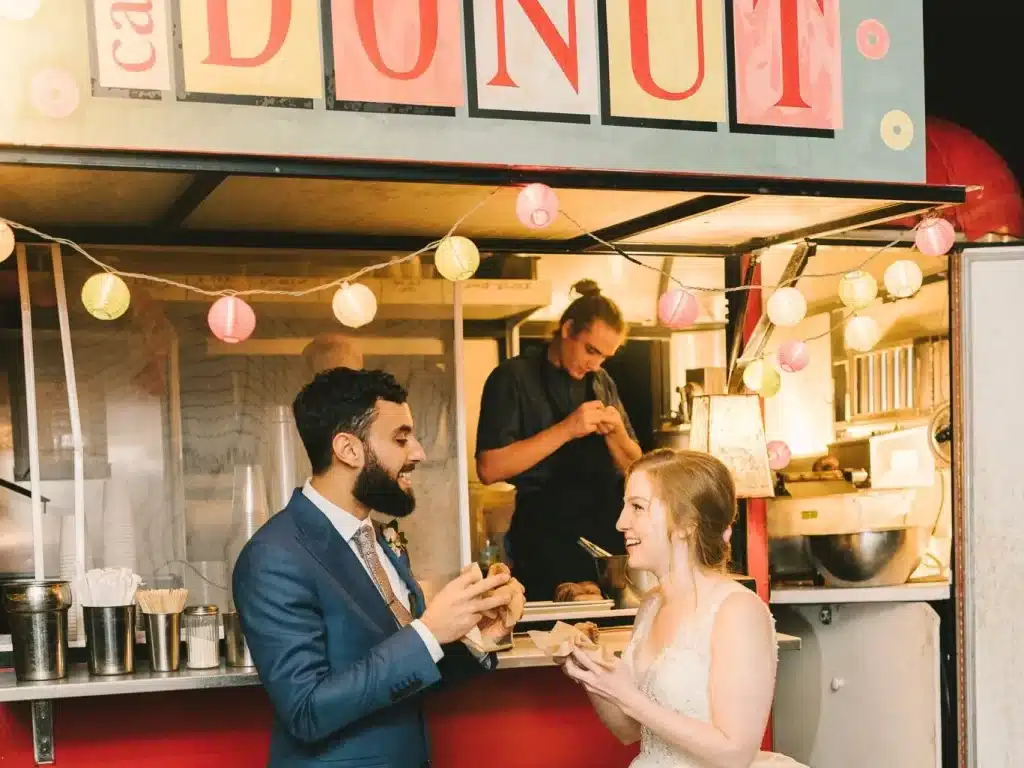 A happy married couple eating food at a food truck