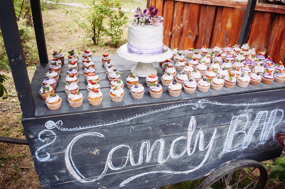 A view of a cake and cup bar at a wedding