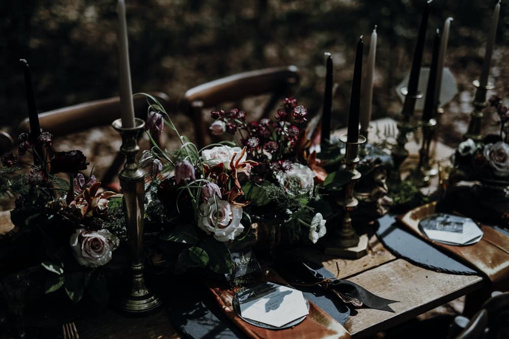 A view of a dark flowers setup on a wedding table