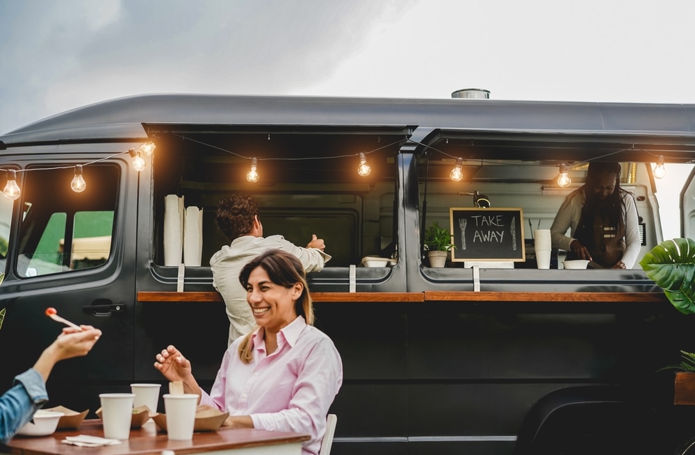 A view of people having fun in front of a food truck