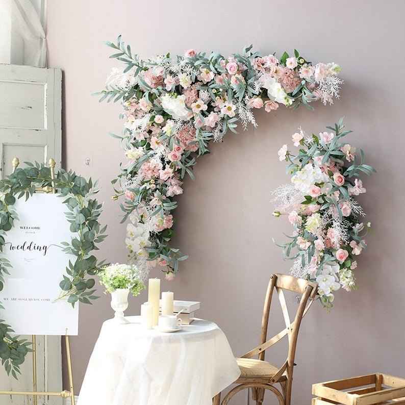 a minimal wedding decor with sage green and blush color flowers