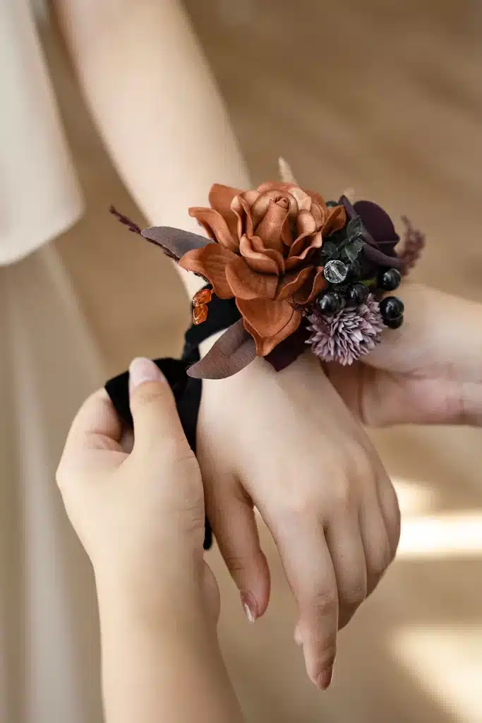 a woman tying corsage on other womans wrist
