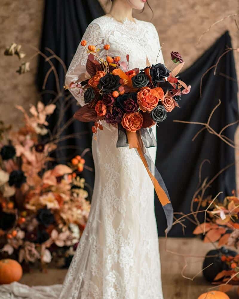 bride in white gown holding a halloween inspired bouquet