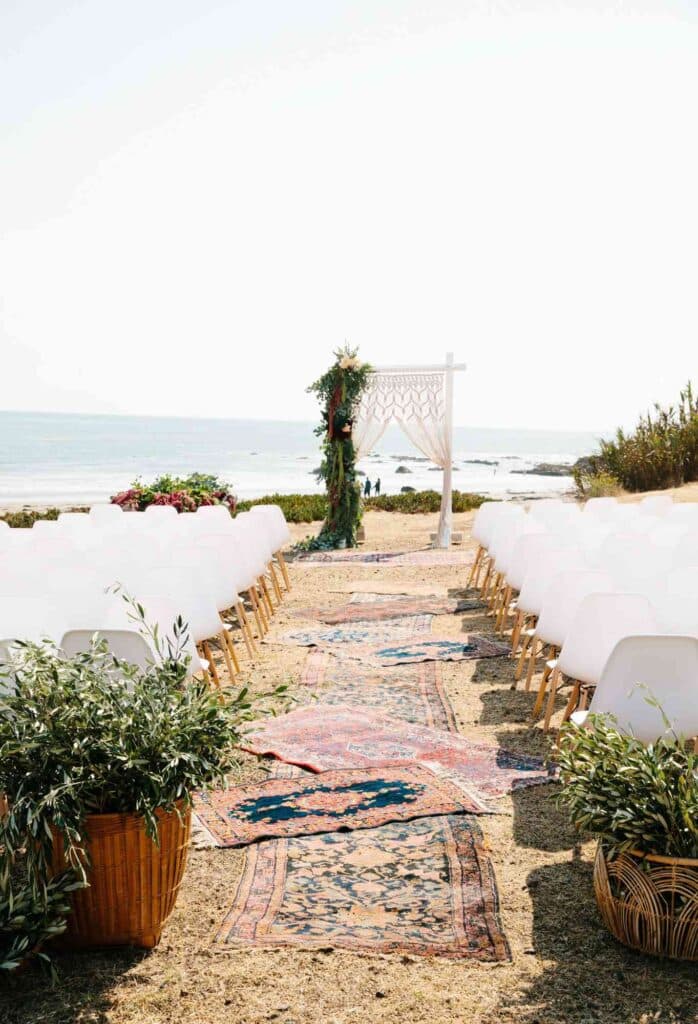 culture inspired aisle with vintage rugs along seaside