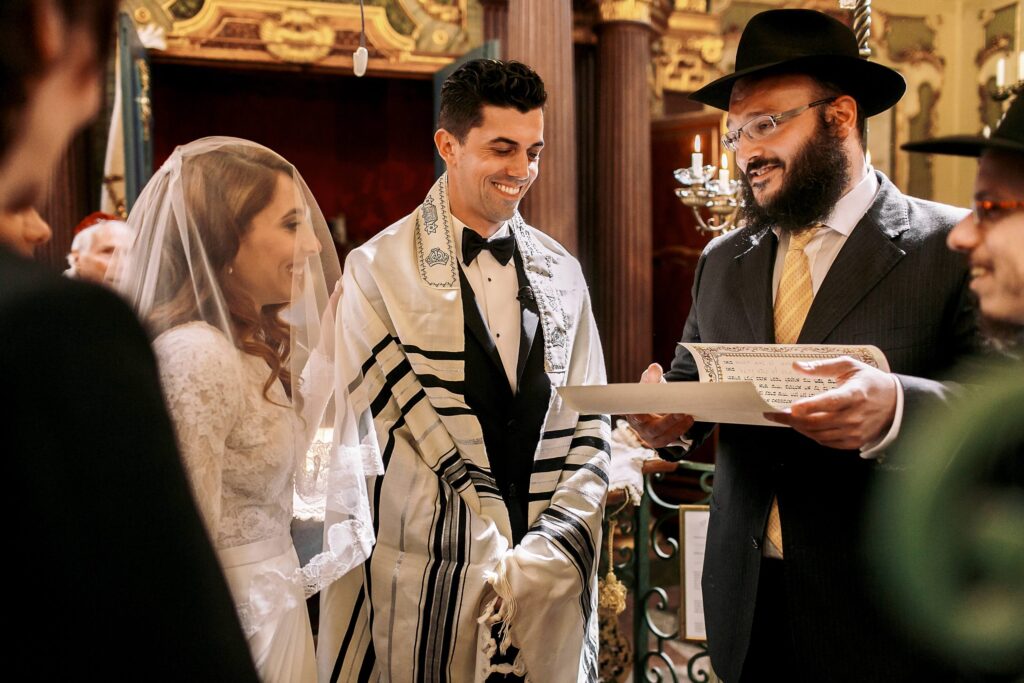 A view of a jewish bride and groom with the priest reading the script