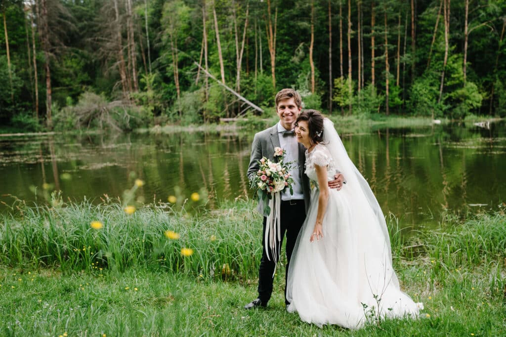 A view of a non denominational traditional couple posing in grass