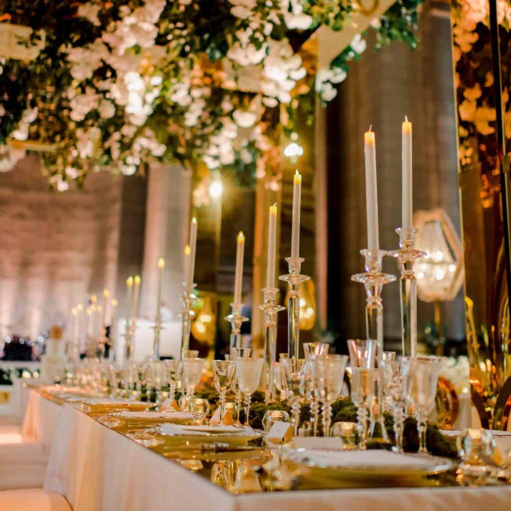 A view of a candle lit arrangement at a wedding table