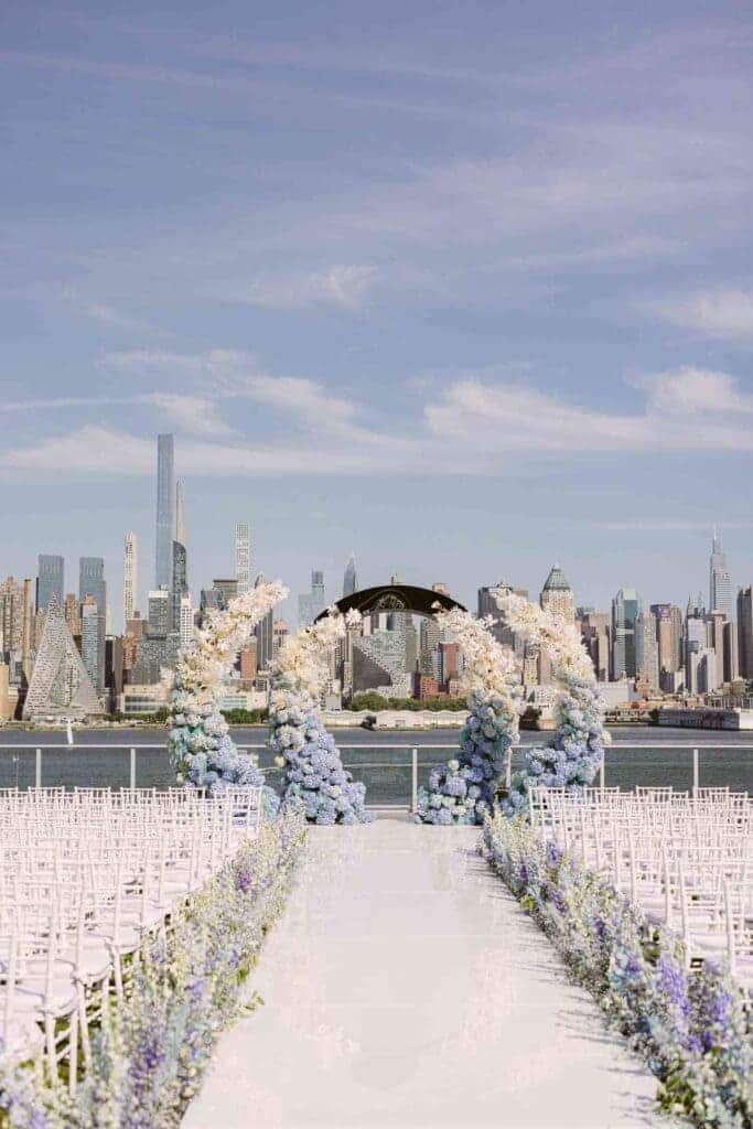 A view of a wedding aisle with lavender floweras outdoors