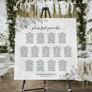 A view of a wedding seating chard board with floral decor