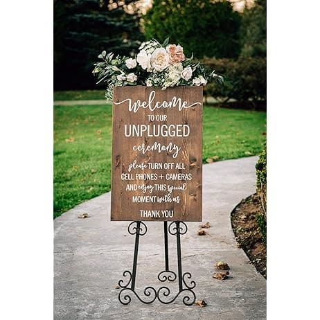 A view of a wooden wedding sign placed outdoors