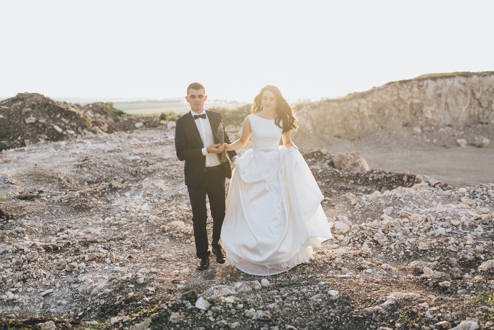 Wedding Couple Poses On A Stone Quarry At Sunset