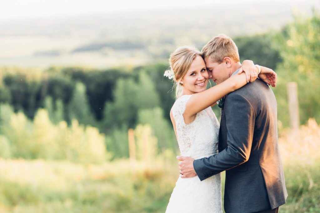 a couple pose for the wedding photos