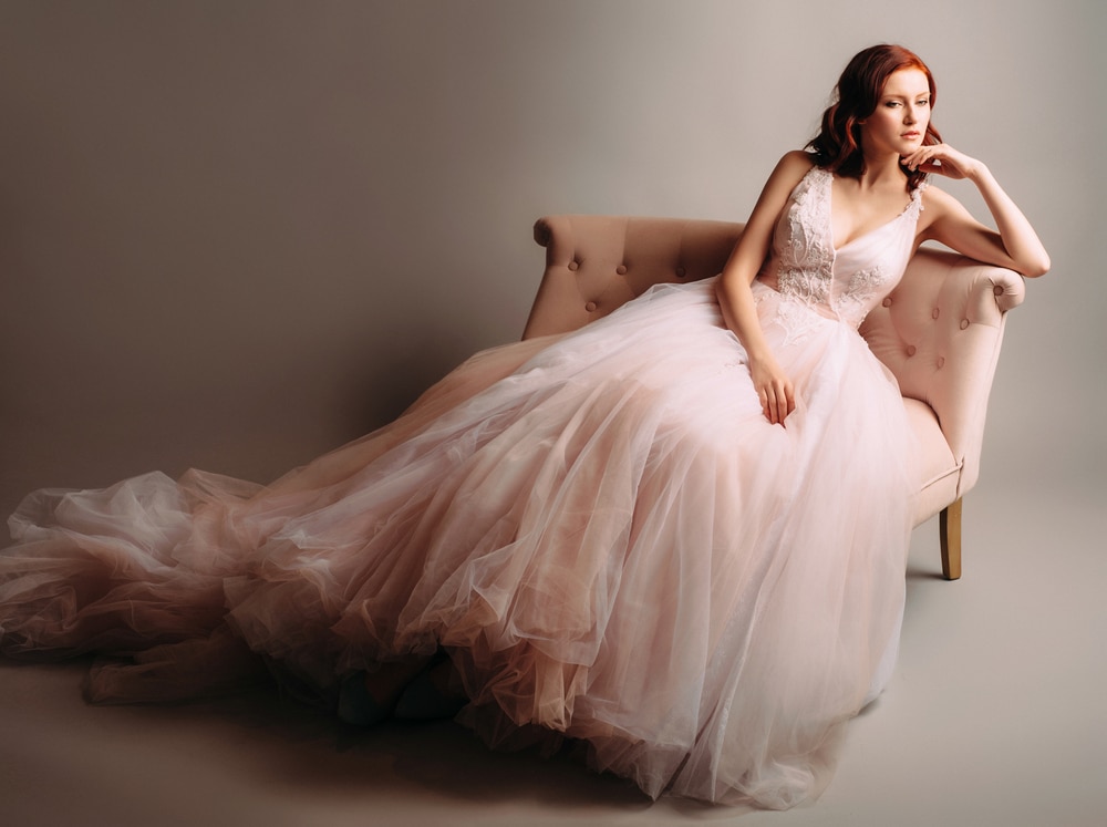 Redheaded Bride In A Pink Wedding Dress Sitting In A