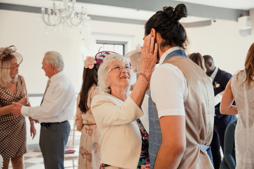  woman is appreciating her grandson on his wedding day