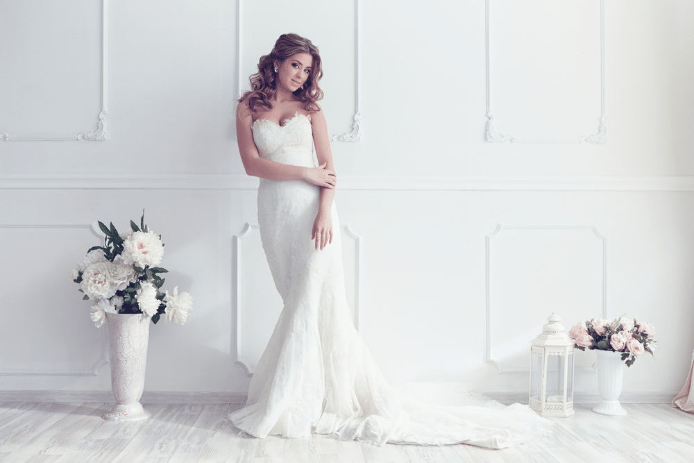 Young beautiful bride wearing mermaid gown in antique interior