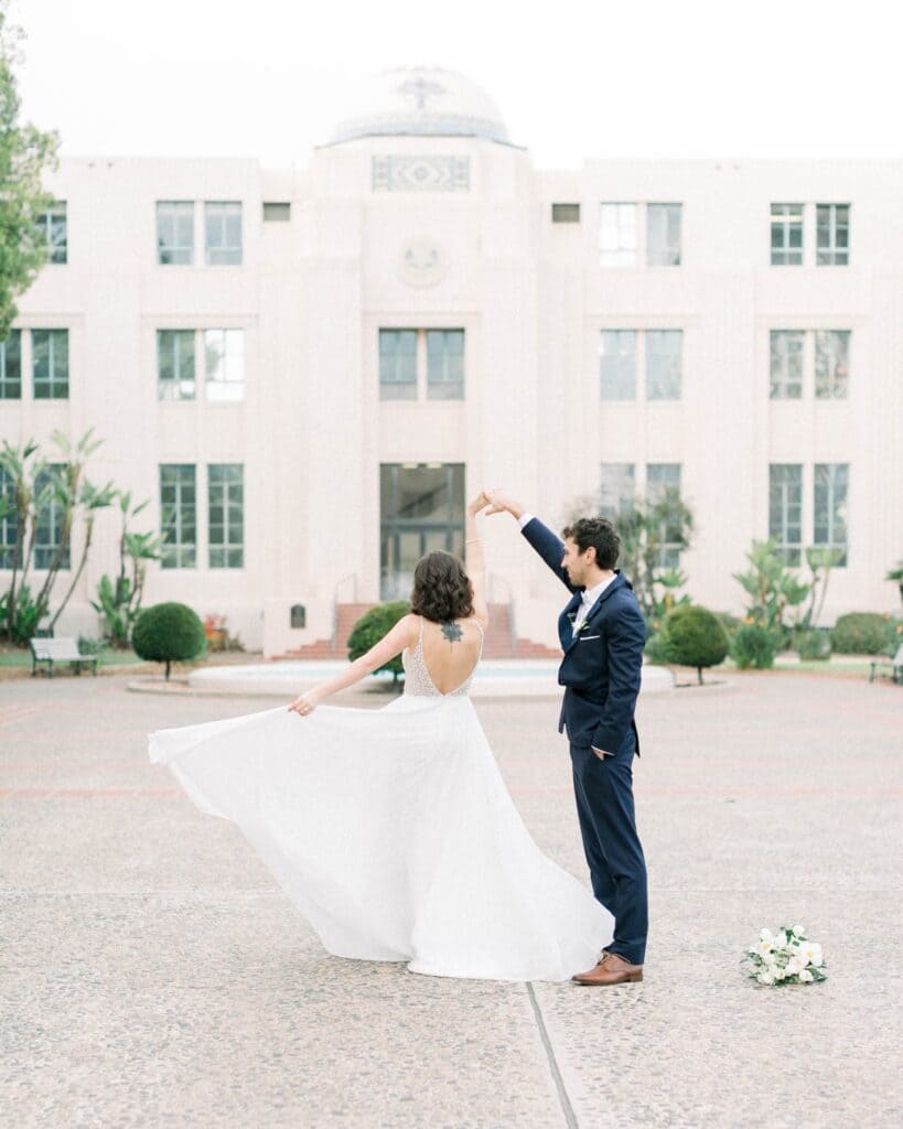 a bride is twirling by her husband