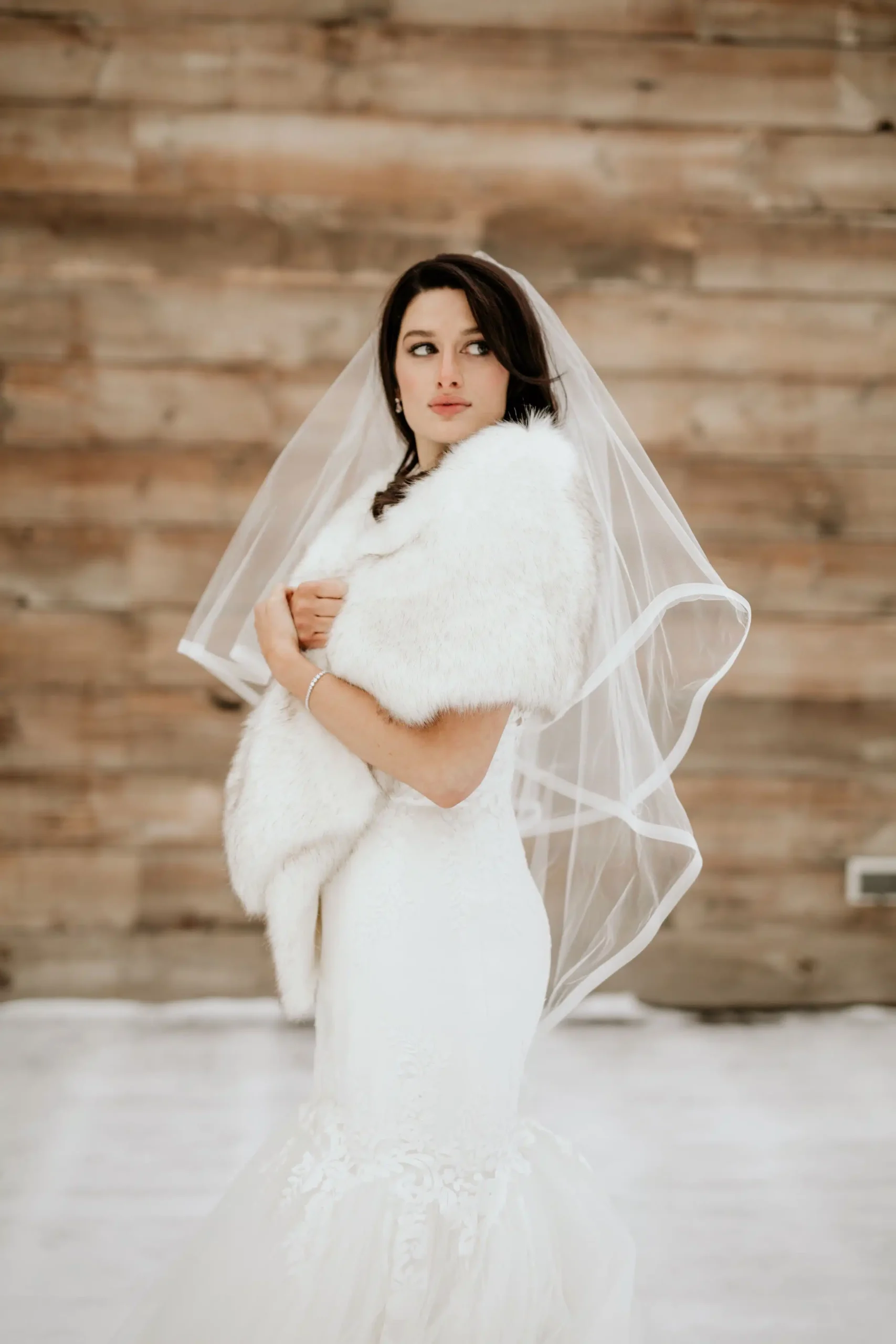 a bride wearing teh fur faux with the white wedding dress