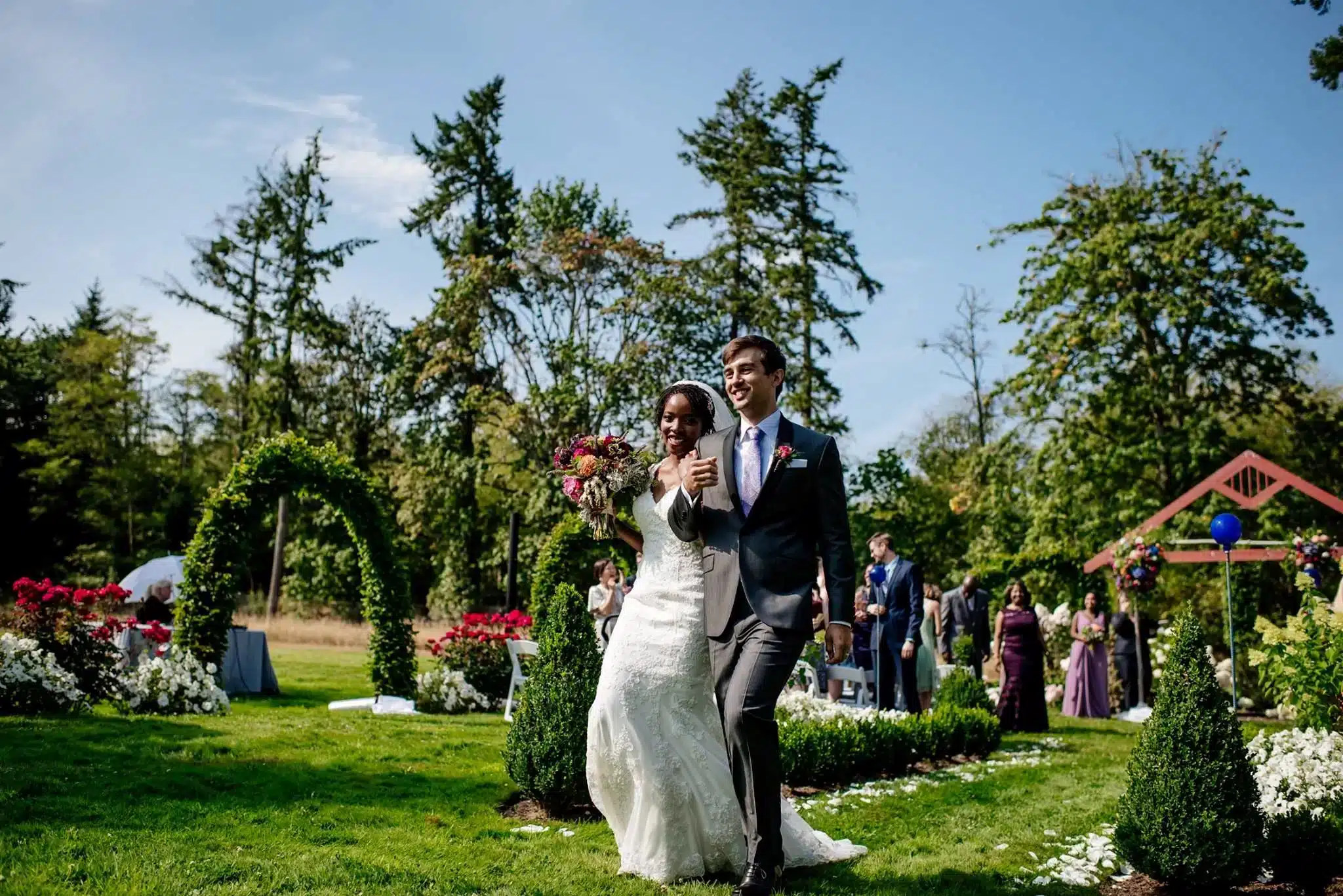 a couple is walking through wedding aisle in Sodo Park Washington 