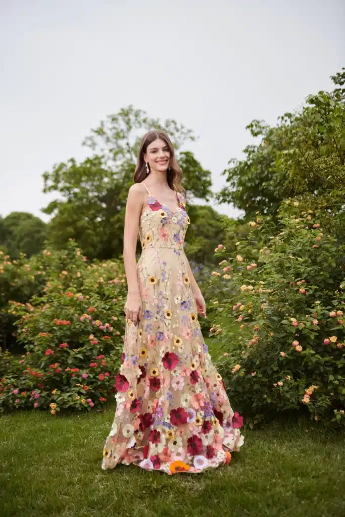 a girl is wearing floral maxi standing in the garden