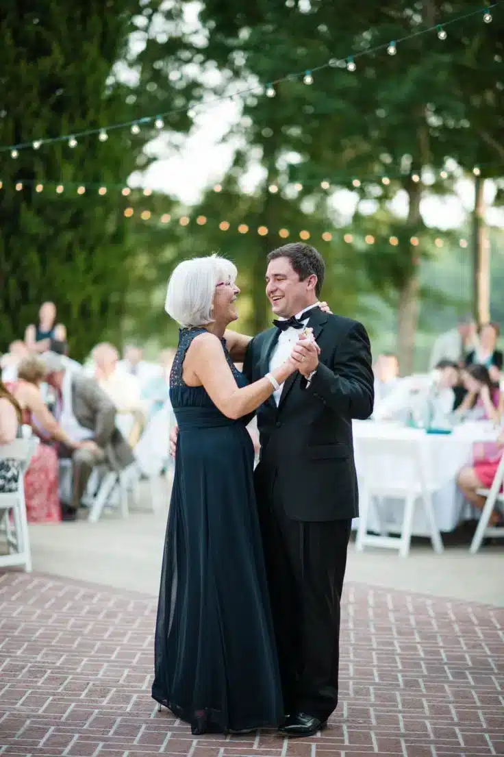 a mother and son dancing on a dance floor