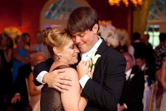 a mother and son hug eachother at sons wedding