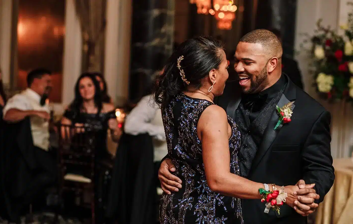 a mother dancing with the son both wearing black dresses