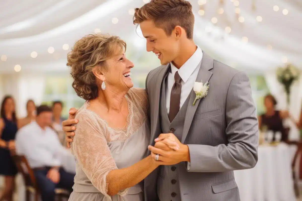 a mother smiling at her son while dancing on sons wedding