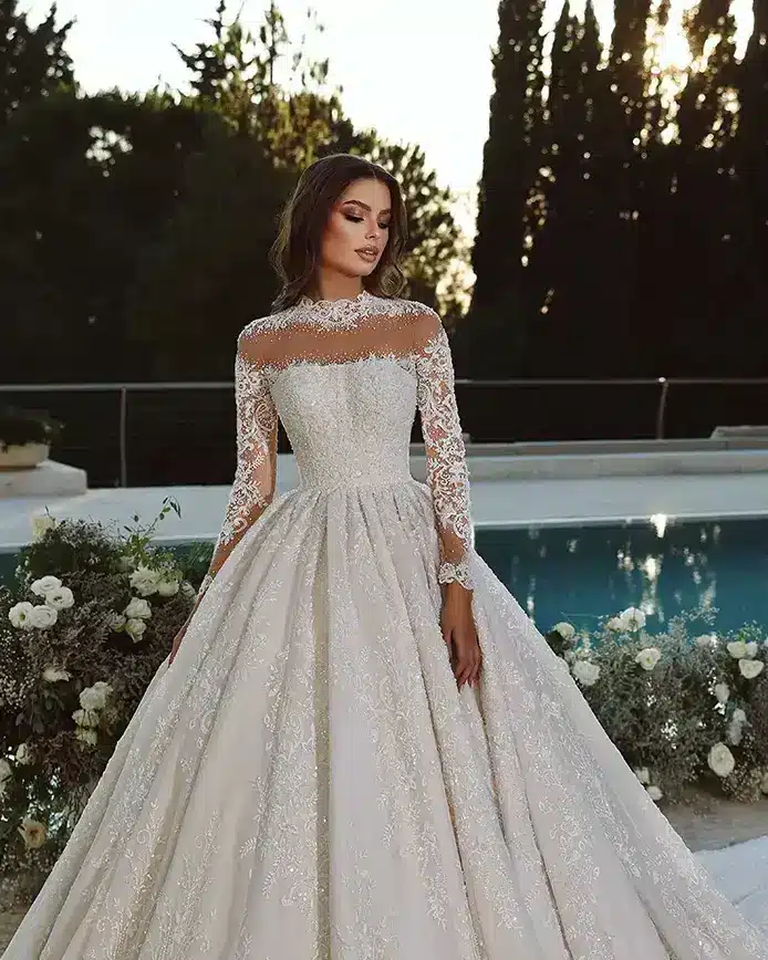 the bride wearing ball gown wedding dress with long sleeves lace illusion neckline vladiyan