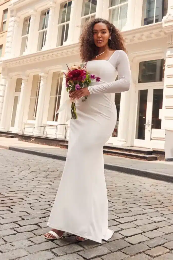 bride wearing white wedding dress and have a flower bouquet in her hands 