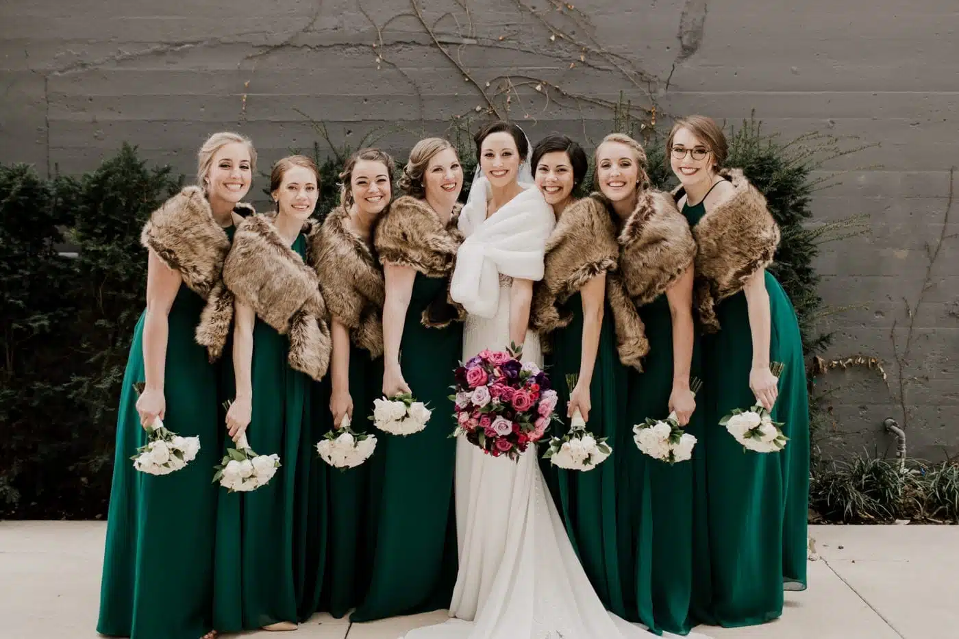 bride wit her bride maids along with the flowers in the hands