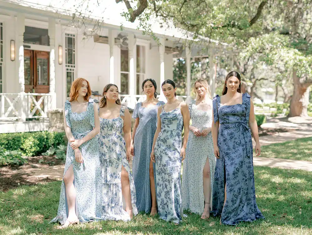 bridemaids wearing blue floral dresses and posing for the pic