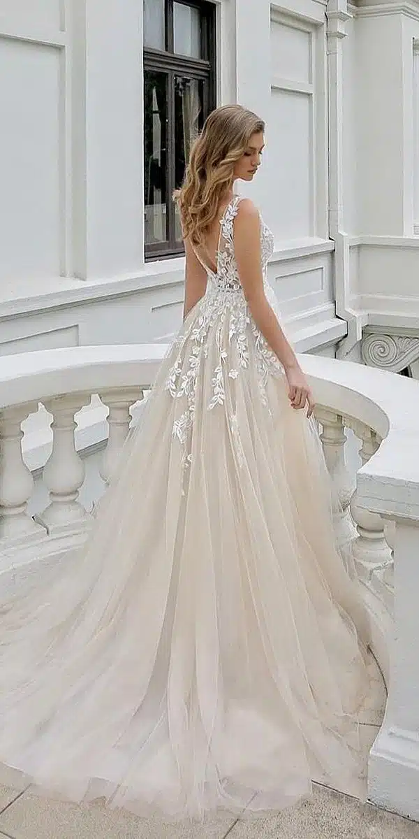 women wearing a line wedding dress standing on the stairs