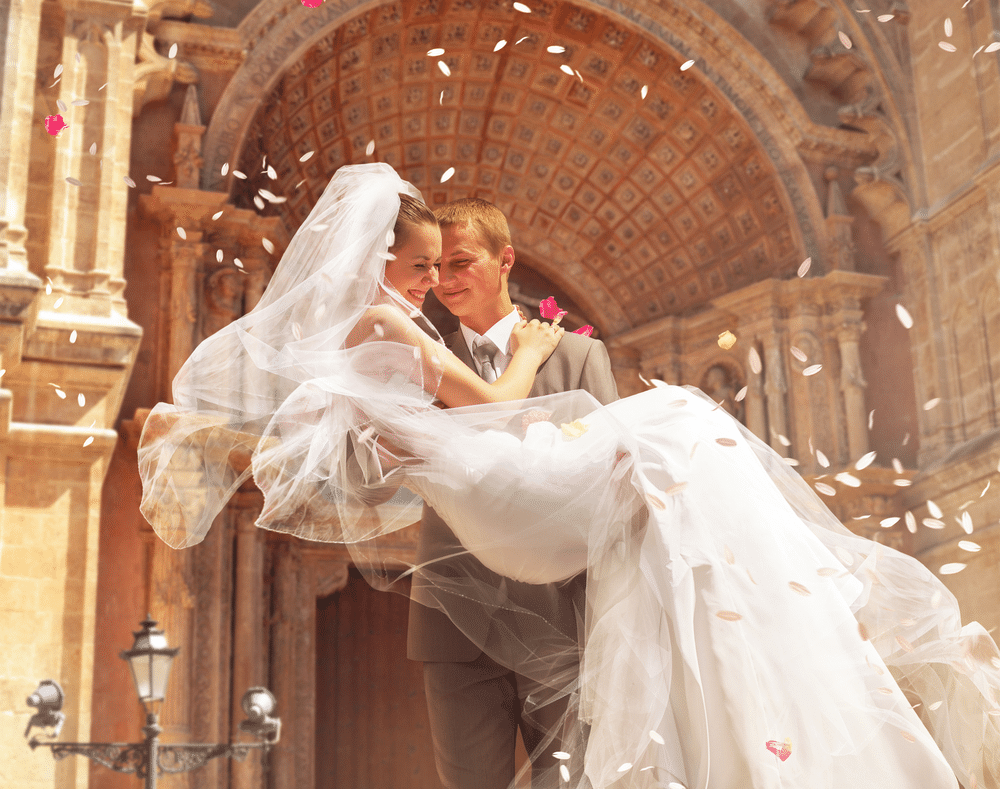 groom holding her bride on a wedding day 