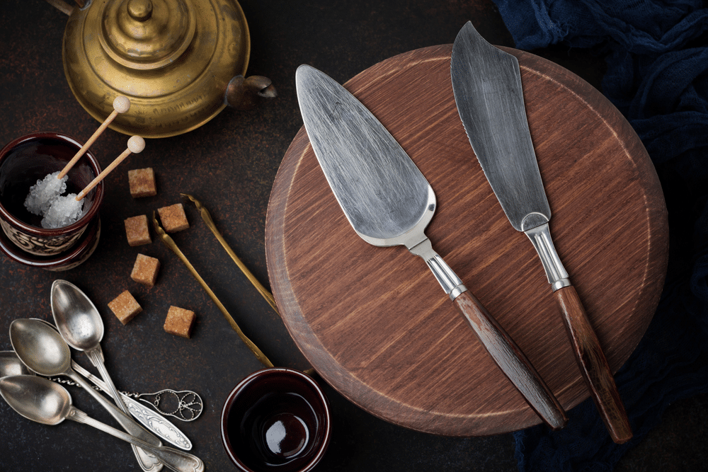 Vintage spatula and knife for cakes on a dark stone or concrete background